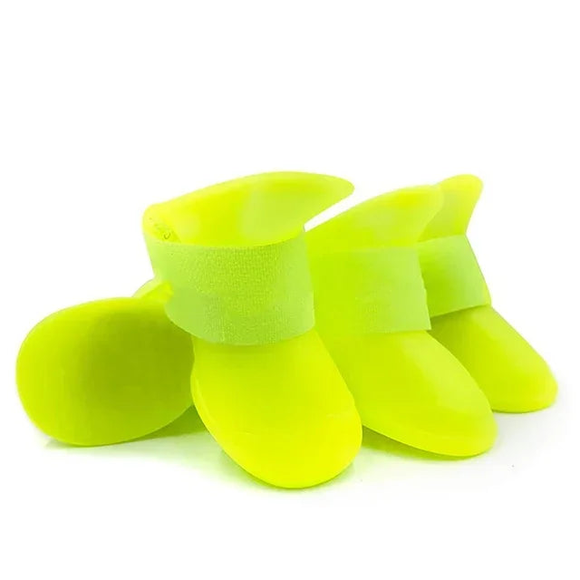 Four bright yellow dog boots on a white background