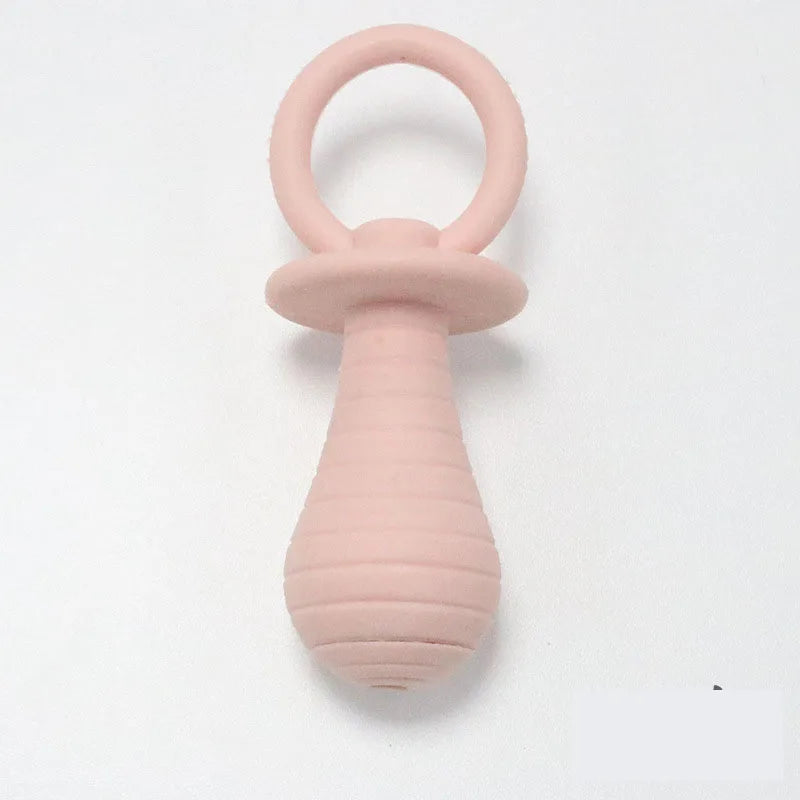 Pink silicone teething ring on a white background