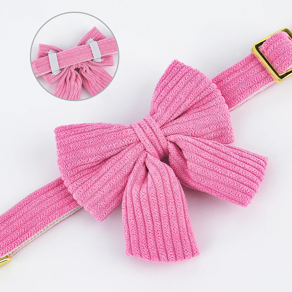 Pink textured bow with a gold buckle on a white background
