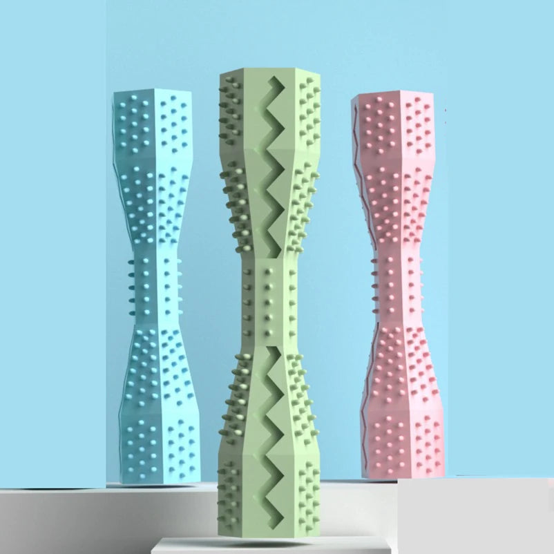Three textured chew sticks in different colors on a light blue background 