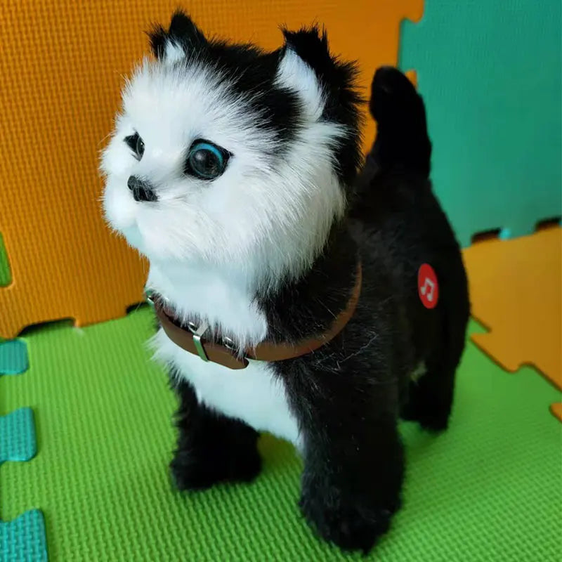 Toy dog with black and white fur on a green mat