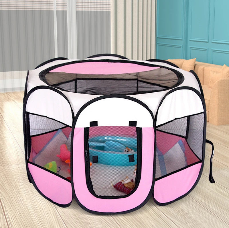 Pink and white pet playpen with toys inside on a wooden floor.