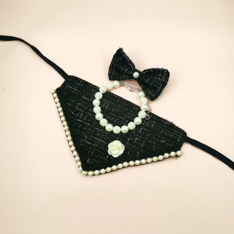 Black  with pearl details and a bow on a beige background