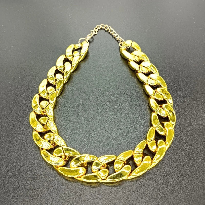 Gold chain necklace on a gray background