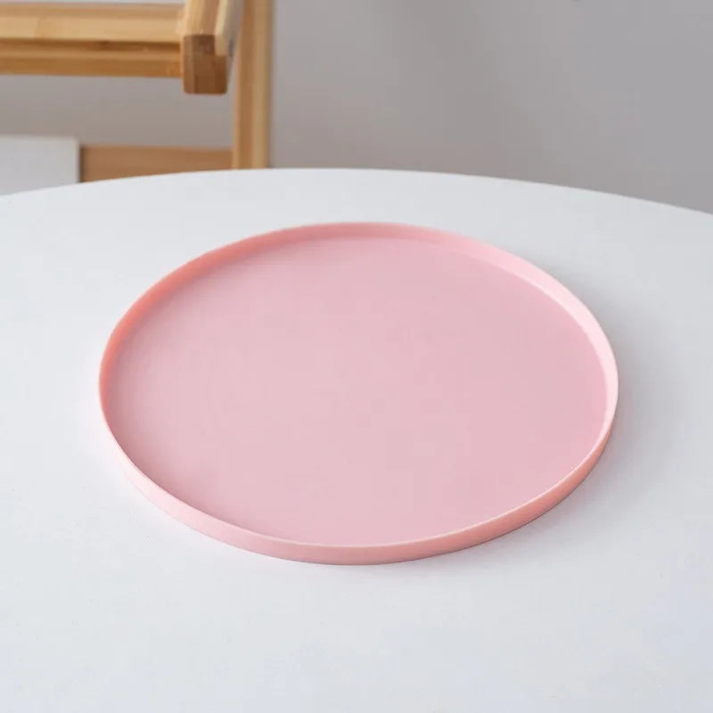 Pink plate on a white surface with a neutral background