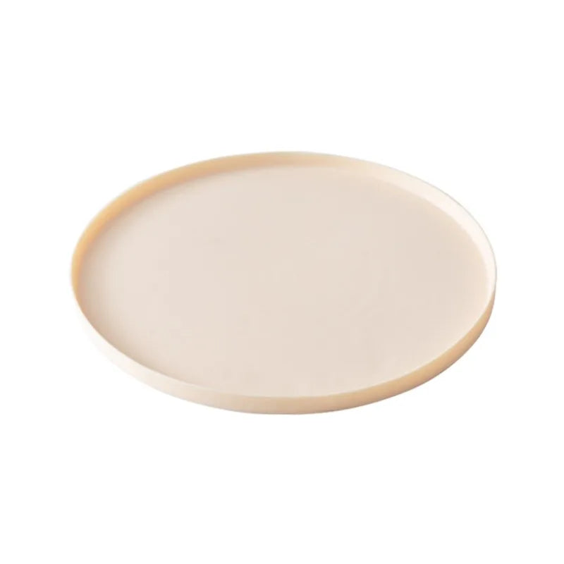 Round beige ceramic plate on a white background