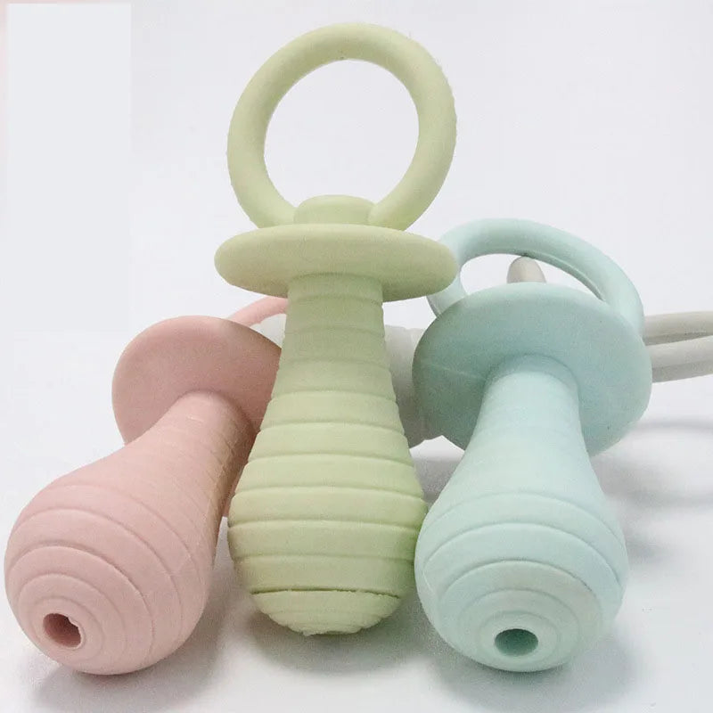 Three silicone teething rings in pastel colors on a white background