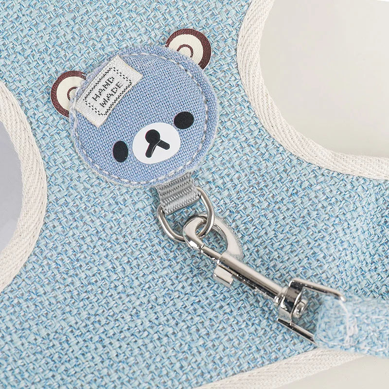 Blue bear-shaped keychain with a key on a blue textured background