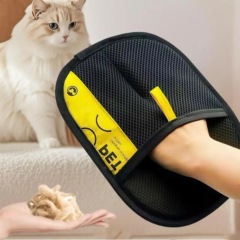 Person displaying a lack and yellow mitt with a cat in the background