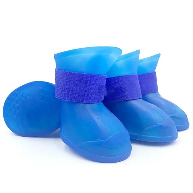 Set of blue pet rain boots with purple straps on a white background