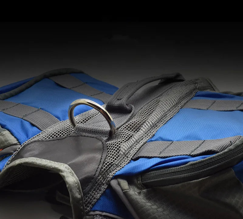 Close-up of a blue and gray dog vest with a metal ring on a dark background