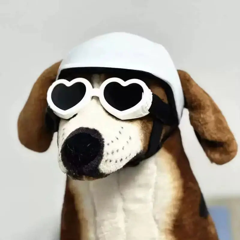 Dog toy resembling a dog wearing heart-shaped sunglasses and a white helmet on a light gray background