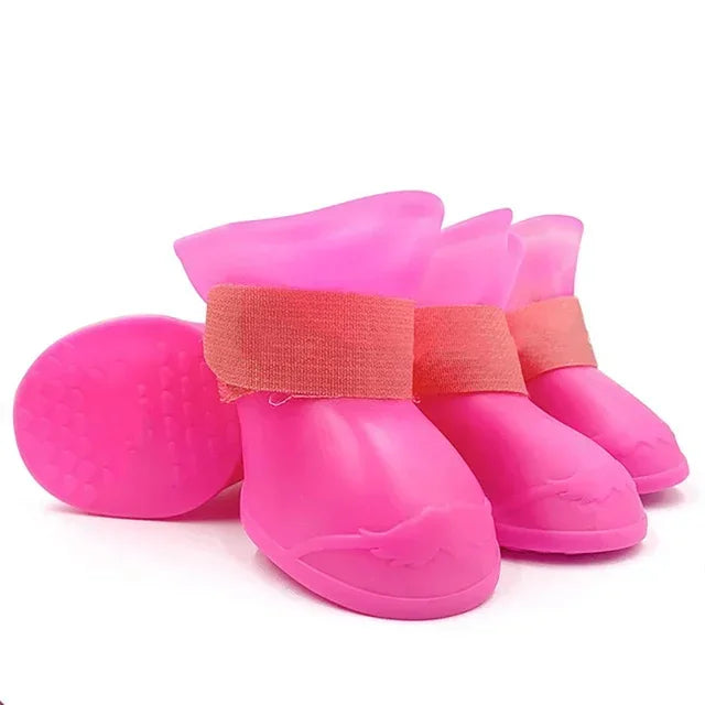 Pink pet rain boots with a strap on a white background