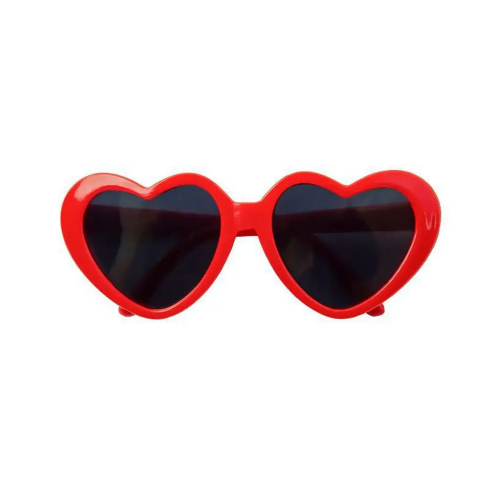 Red heart-shaped sunglasses on a white background