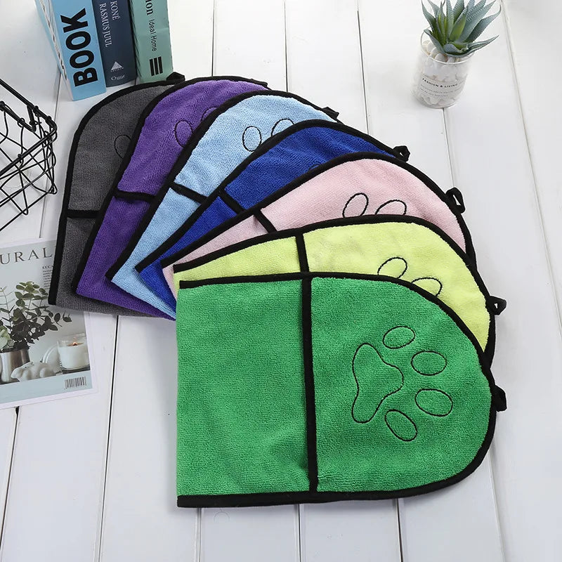 Set of colorful pet towel's with paw design on a white surface.