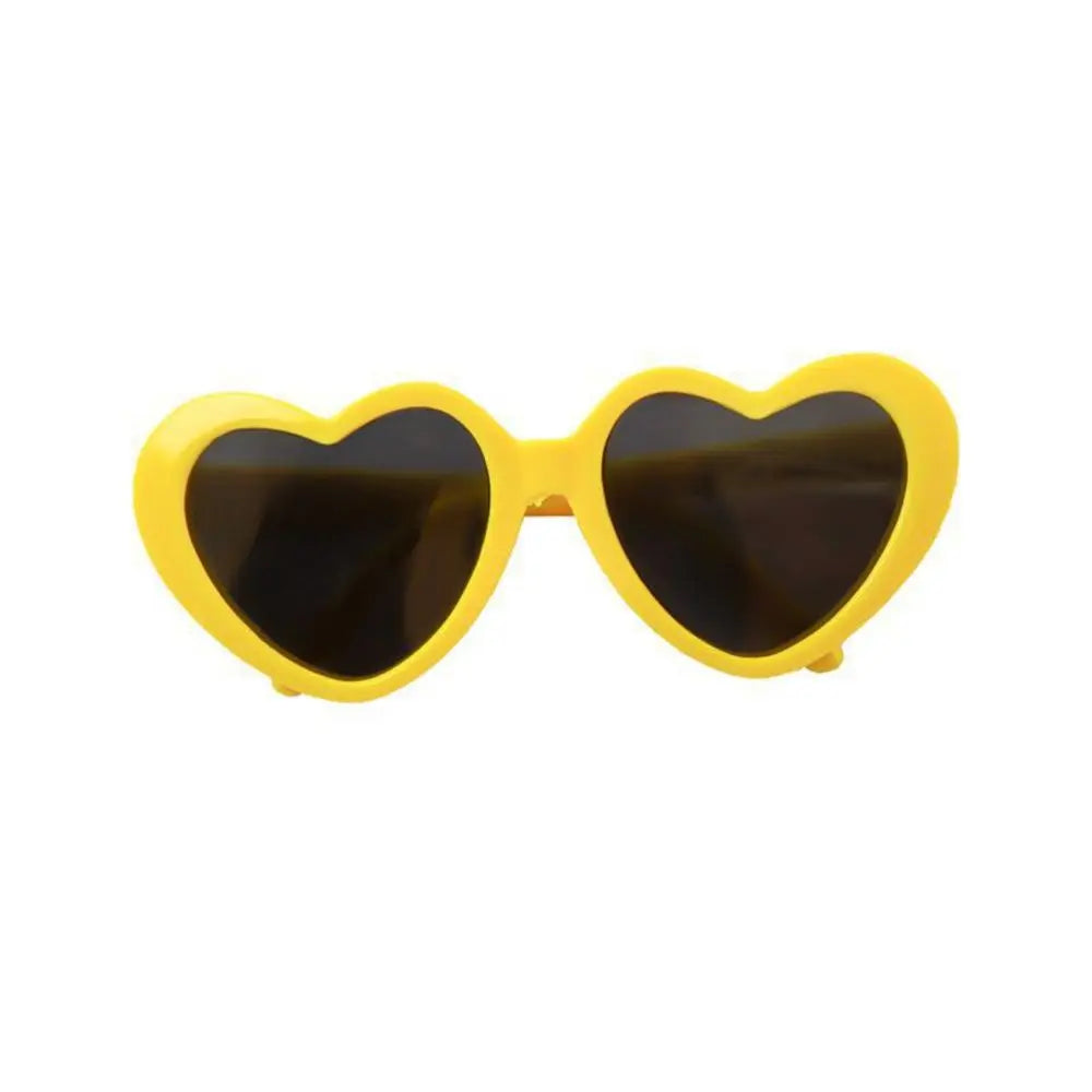 Heart-shaped sunglasses with yellow frame on a white background