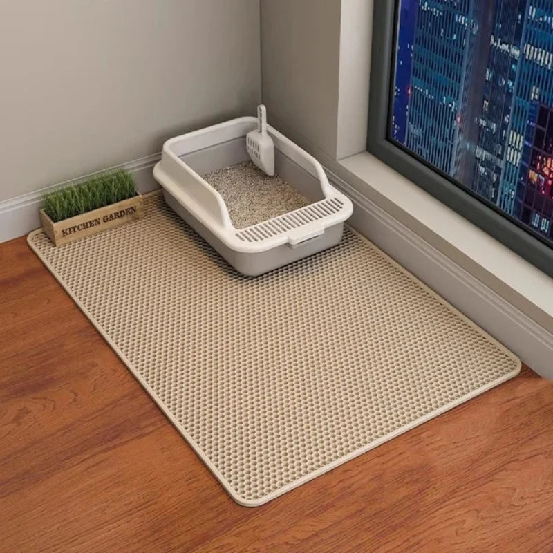 Cat litter box on a mat with a cityscape in the background