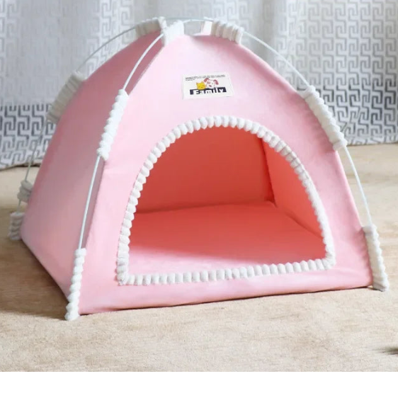 Pink pet tent with white trim on a tan carpet against a white curtain background