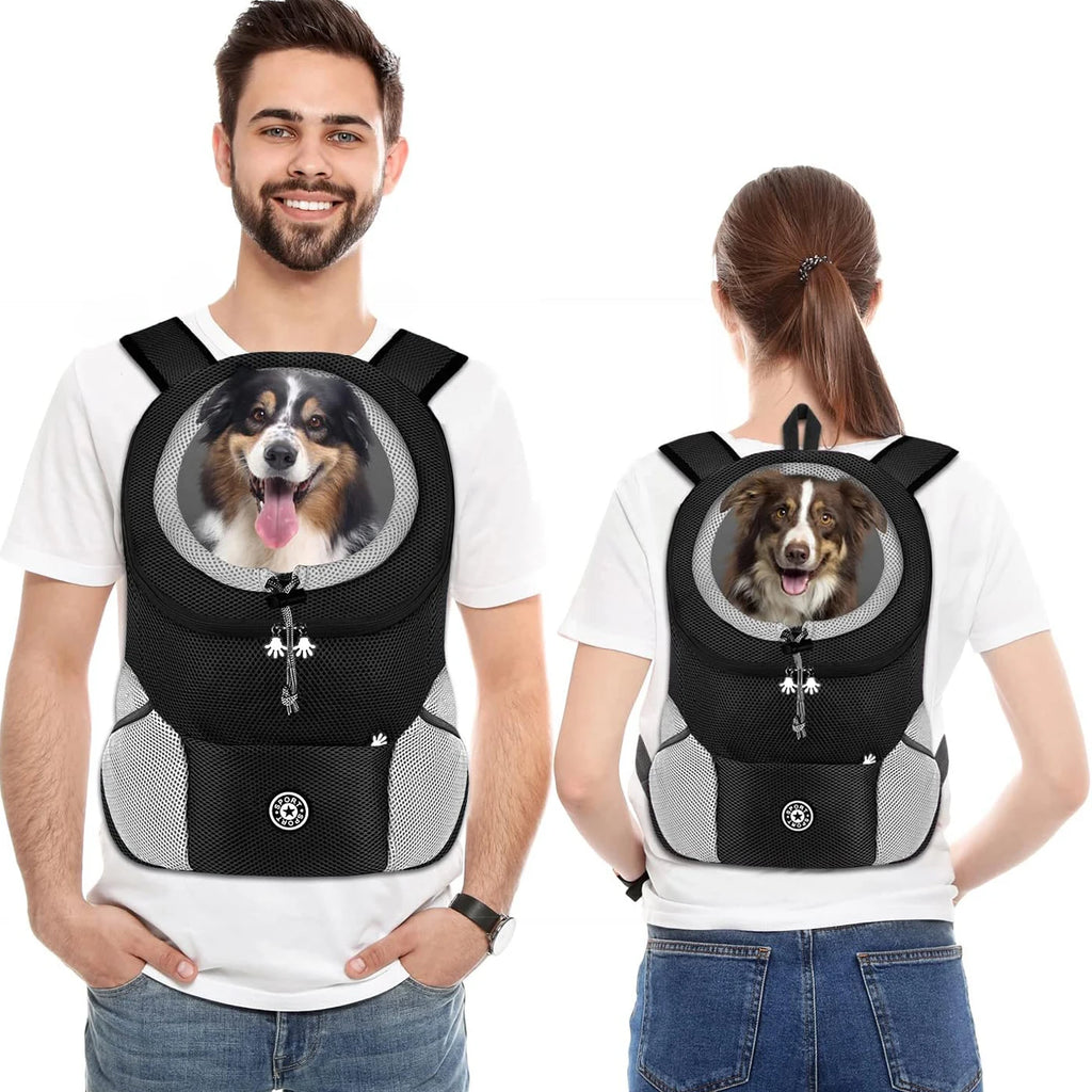 Two people wearing black pet backpacks with a dog inside, on a white background