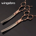 Two pairs of rose gold scissors with 'wingsbro' branding on a dark background