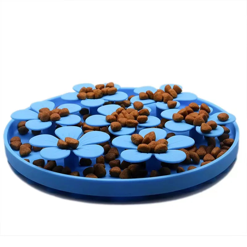 Blue flower-shaped pet feeder with cat food on a white background