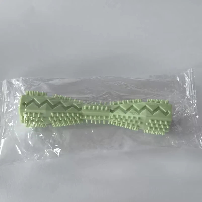 Green textured toy  in clear plastic packaging on a white background