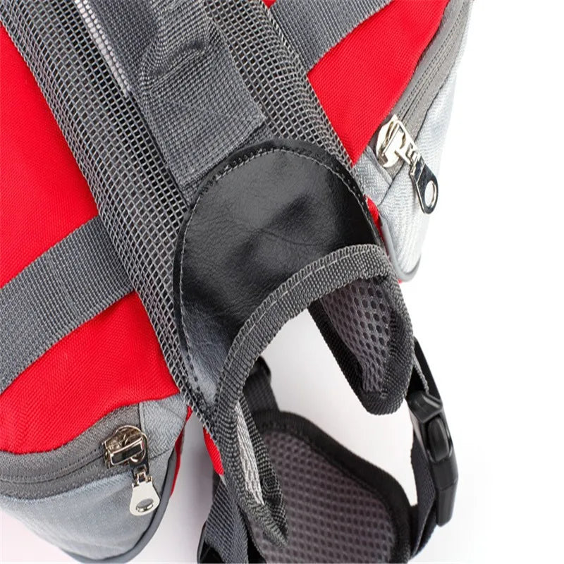 Close-up of a red and gray backpack with straps and zippers on a white background