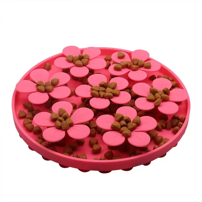 Pink flower-shaped pet feeder with pet food on a white background