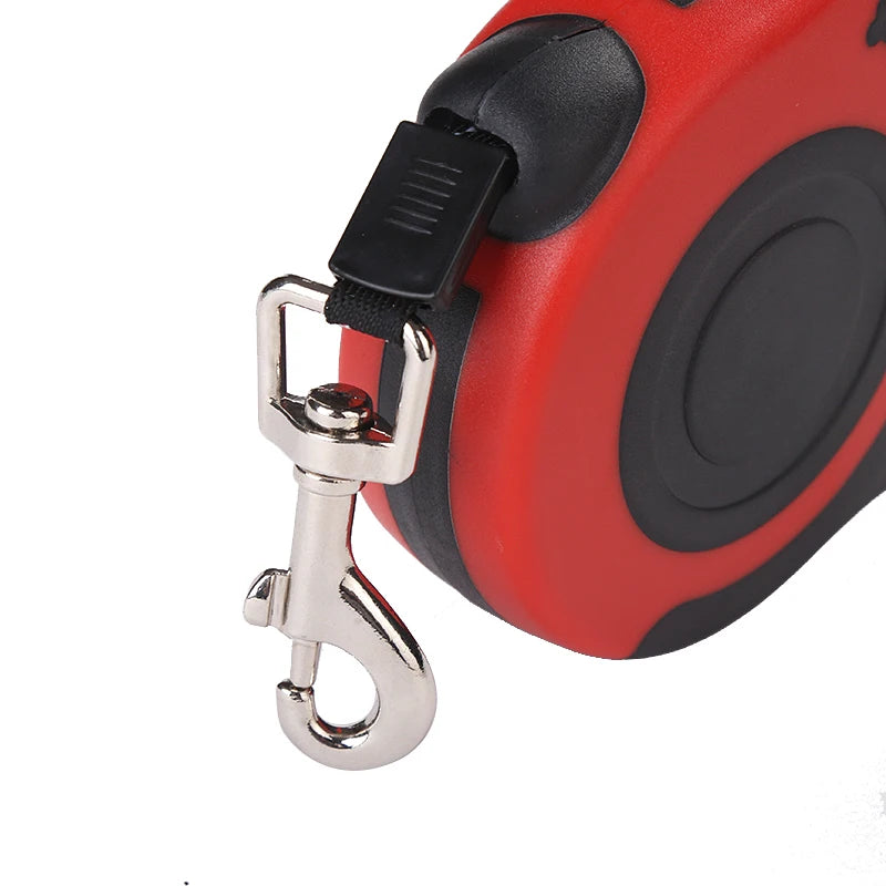 Red and black retractable dog leash with a metal clip on a white background