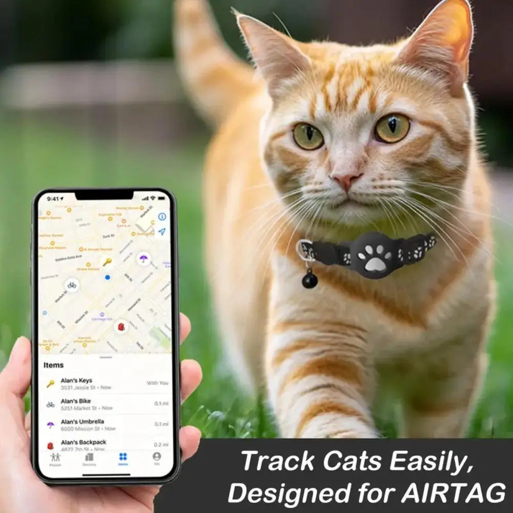 Cat wearing a collar with a smartphone displaying a tracking app, set against a blurred natural background.