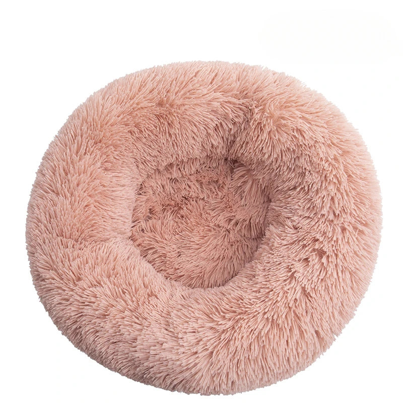 Fluffy pink pet bed on a white background