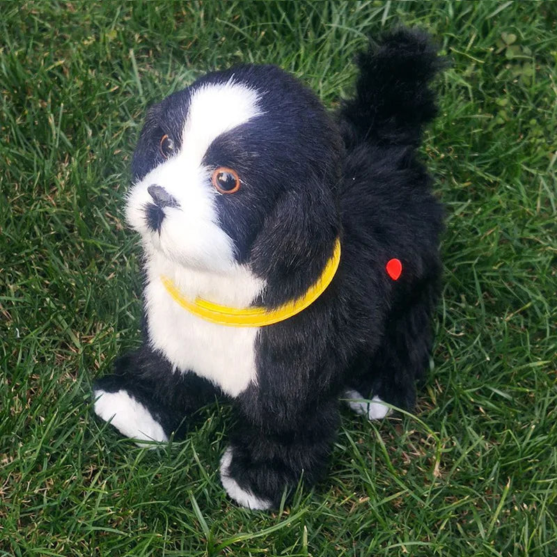 Black and white dog plush toy with a yellow collar on grass