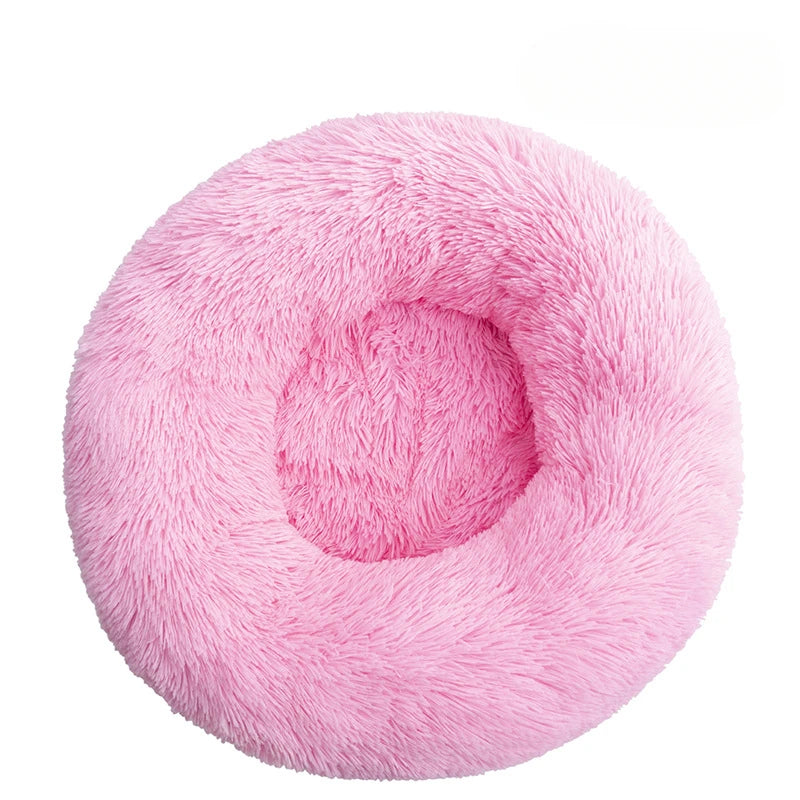 Pink fluffy donut pet bed on a white background