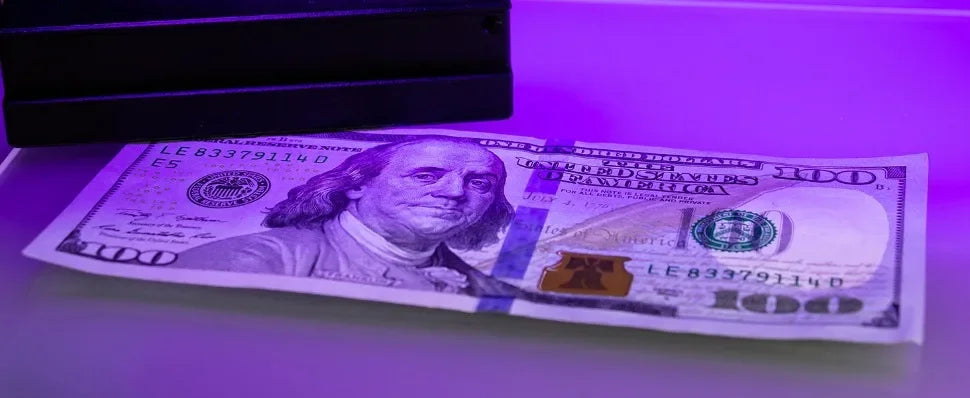 U.S. hundred-dollar bill under a black light