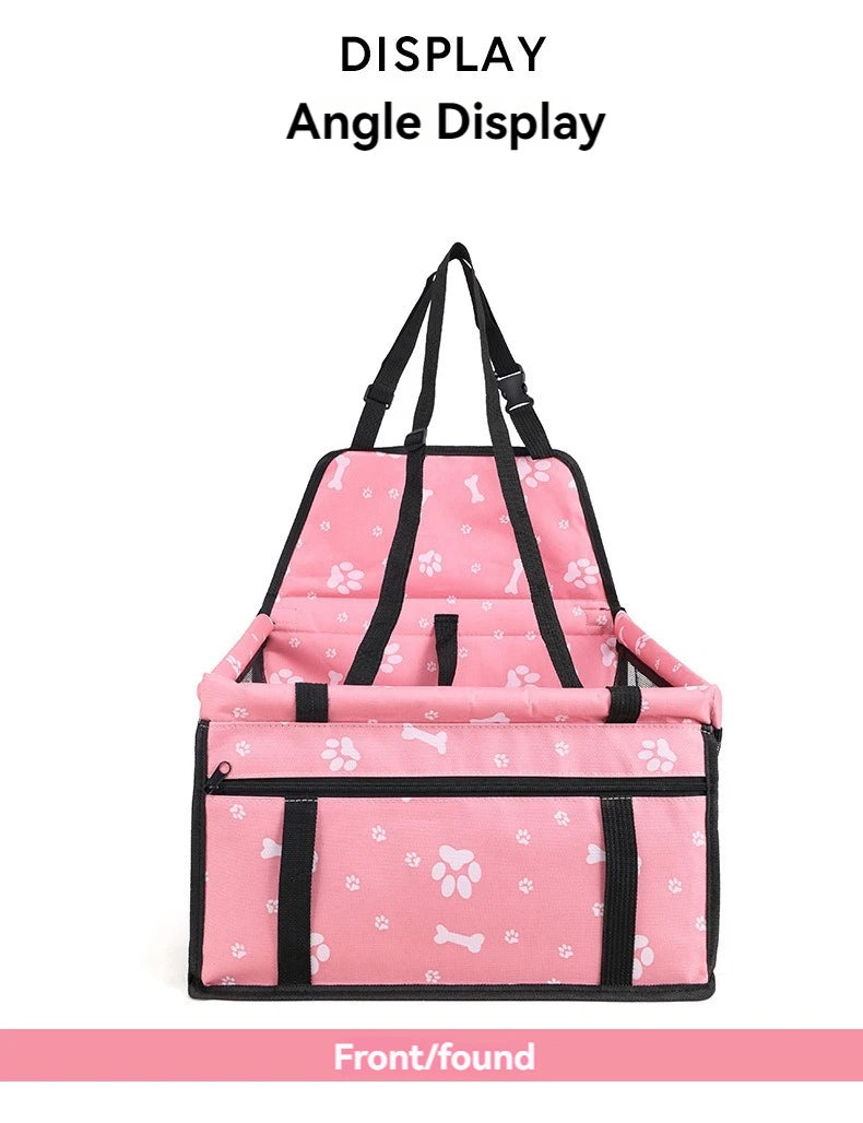 Pink pet carrier with black straps on a white background
