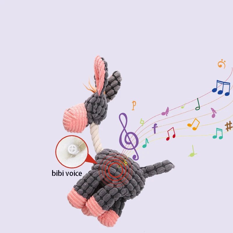 Dog toy with textured parts, featuring musical notes and a 'bibi voice' button on a light purple background.