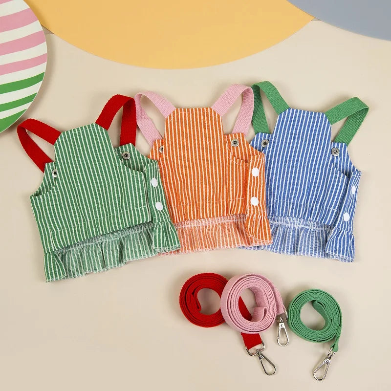 Set of colorful aprons with matching straps on a neutral background
